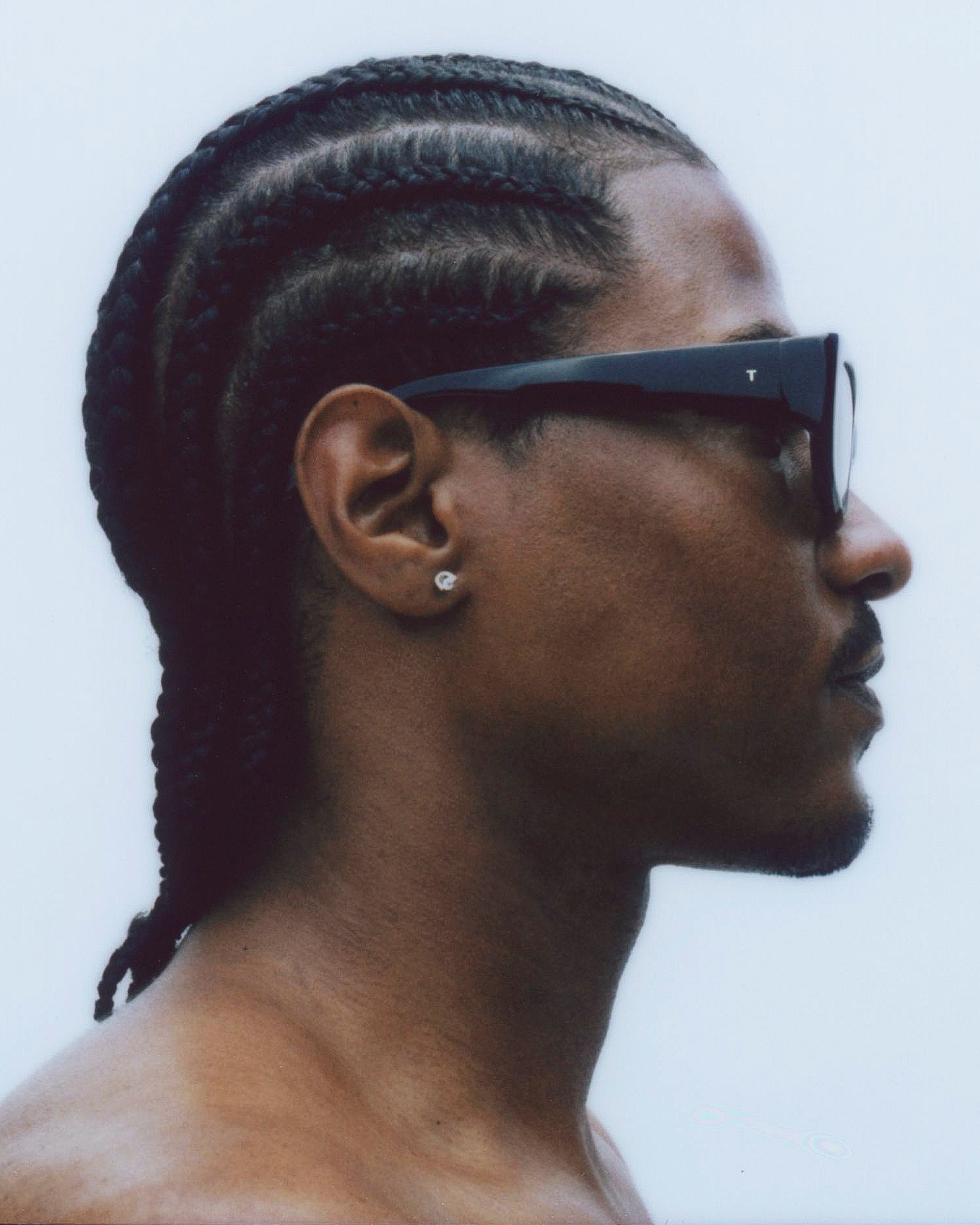 model wearing sunglasses, facing rightward