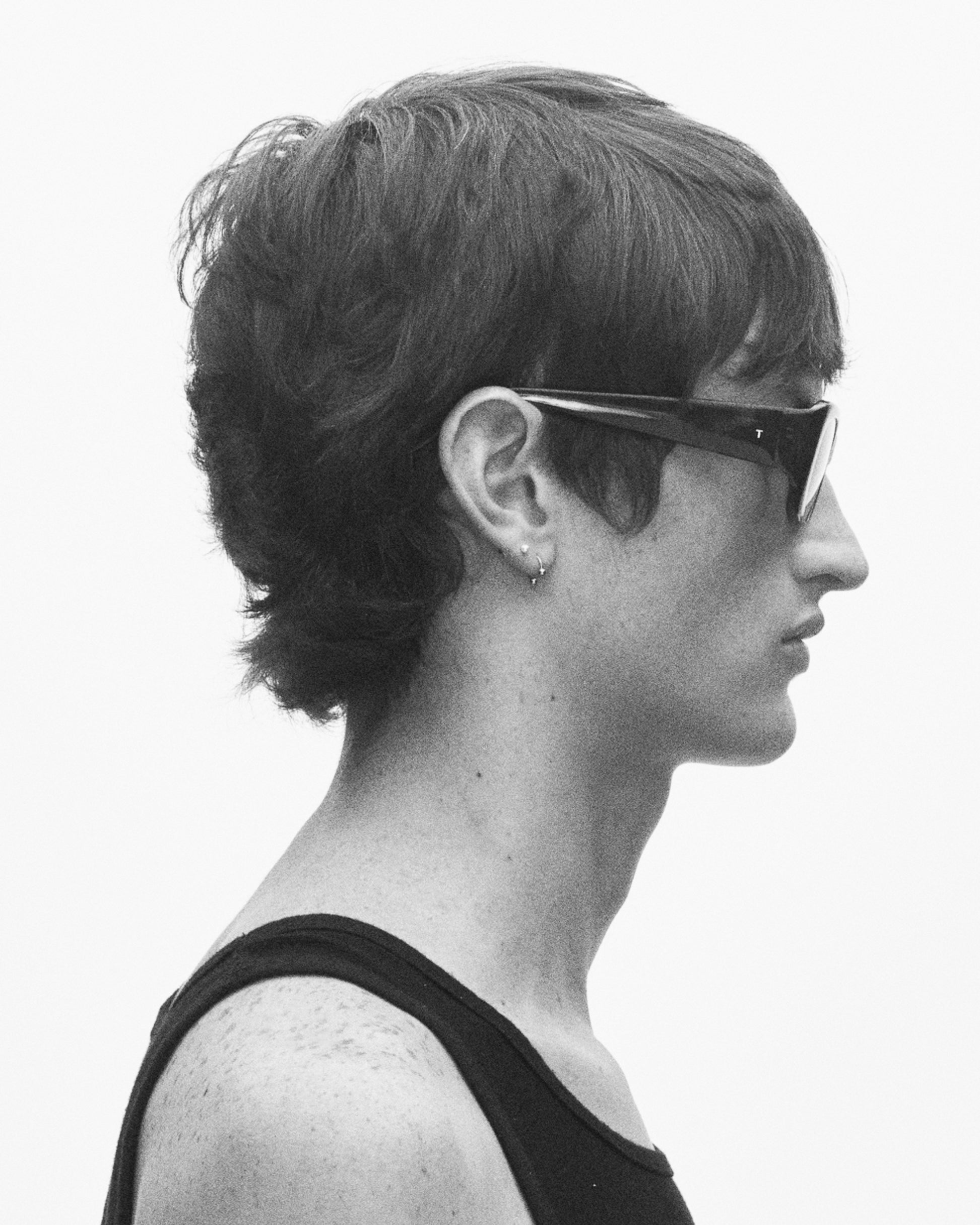 model wearing sunglasses, facing rightward
