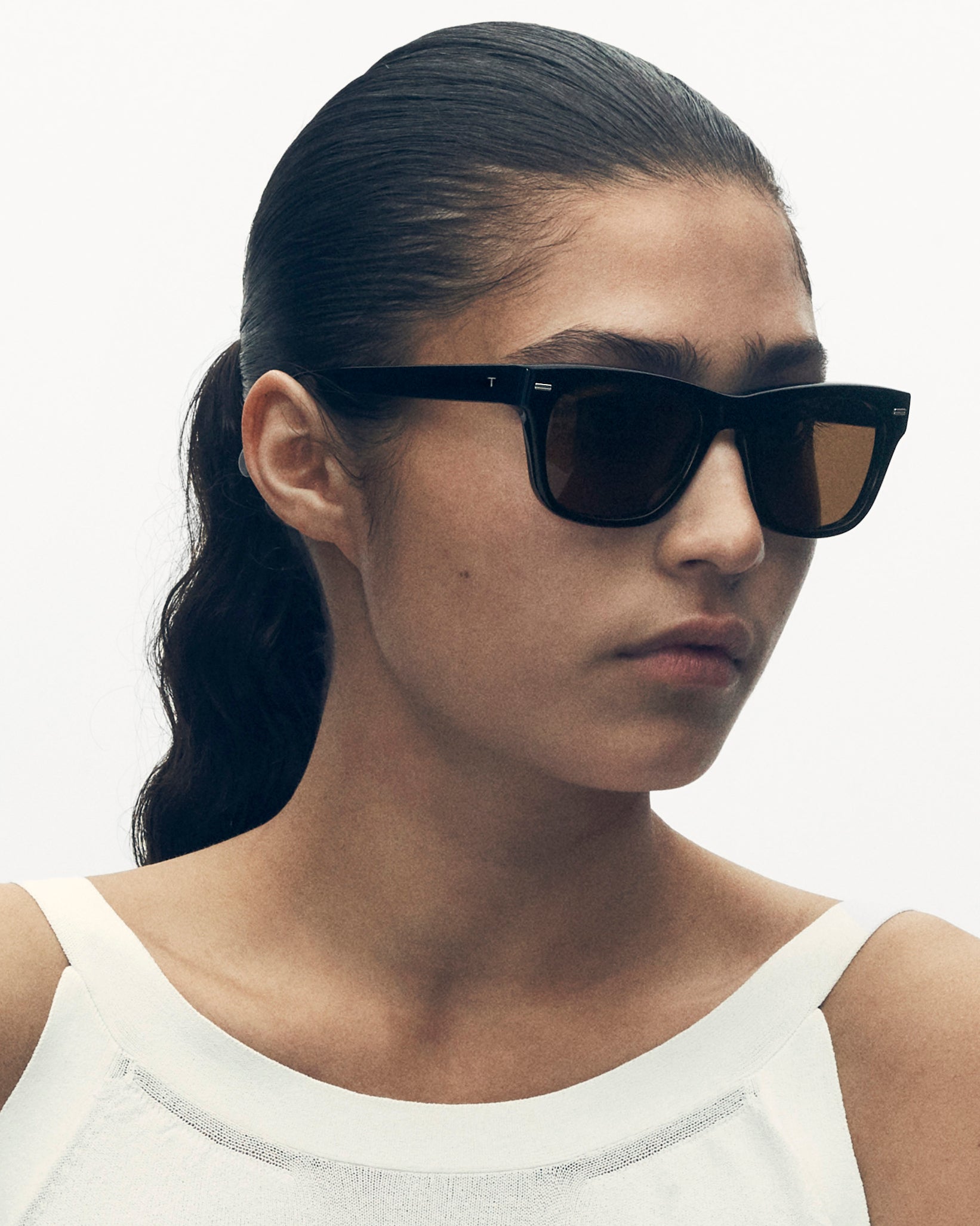 model wearing sunglasses. she is looking off to the side.